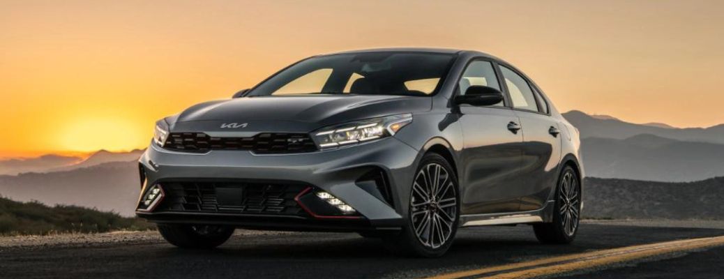 A 2023 Kia Forte backdropped by the evening sky