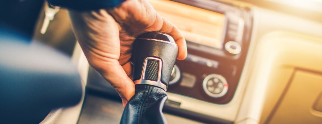 a driver's hand on gear