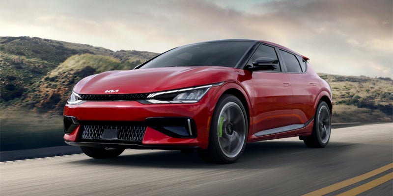 A red 2024 Kia EV6 driving down a highway near Hayward, CA