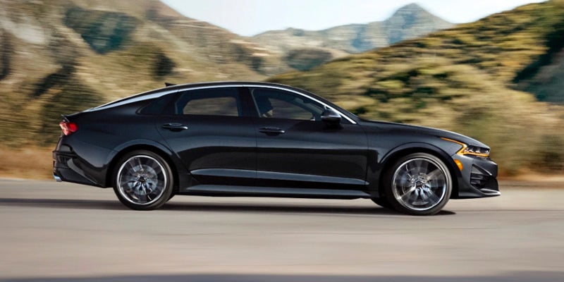 A 2024 Kia K5 driving down a road near Hayward, CA