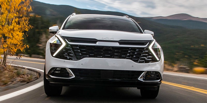 A 2024 Kia Sportage driving down a picturesque highway near Hayward, CA 